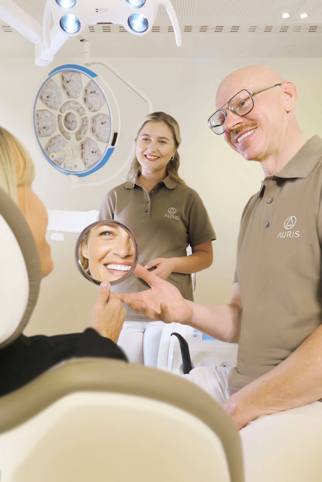 Dr. Schneider and assistant showing a patient the result